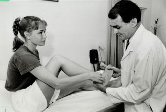 Medical teamwork: Dr. Charles Bull checks Adrienne Dunnett's foot for complications. Rhythmic gymnast fractured the foot in three places almost a mont(...)