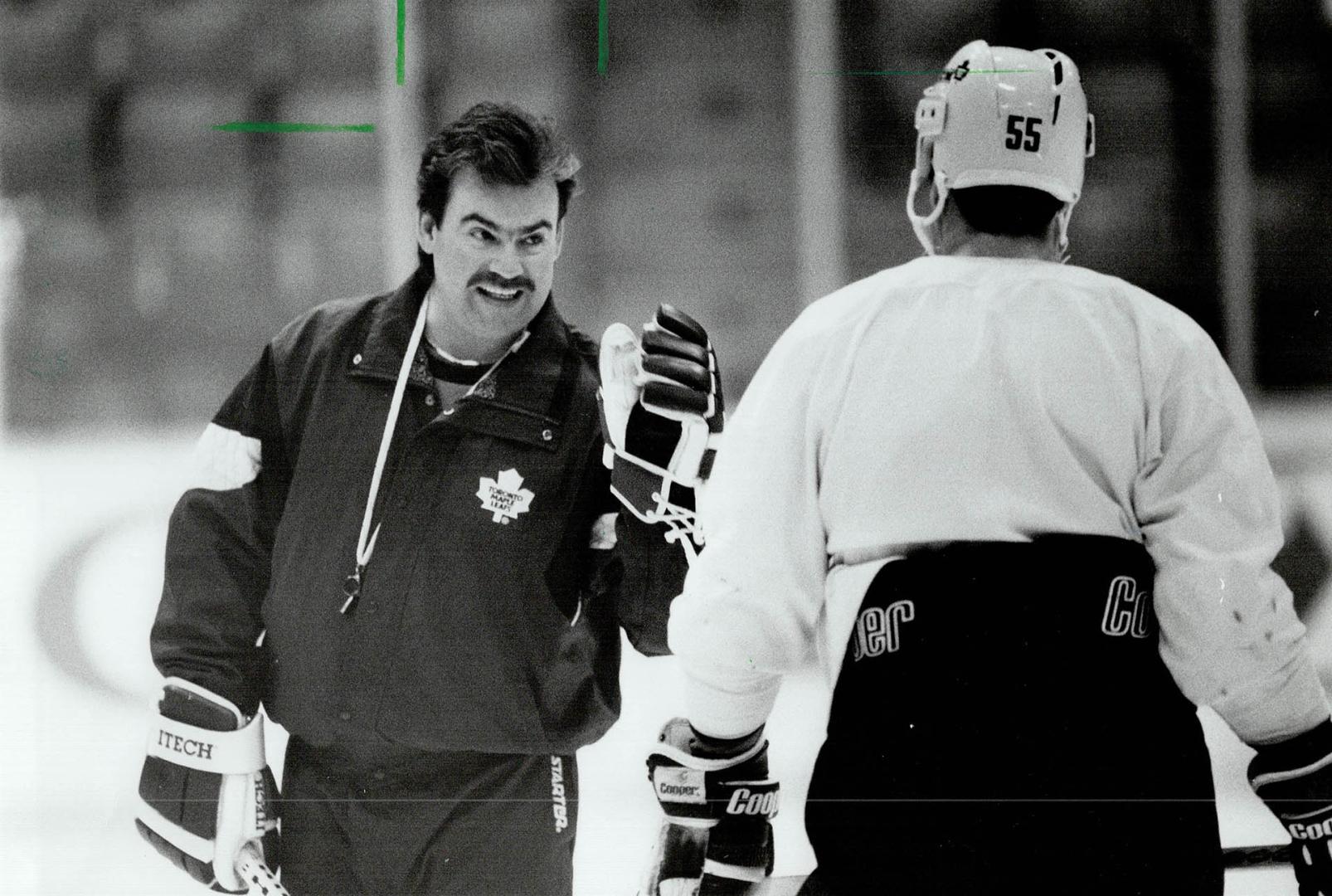 Now hear this: Maple Leafs coach Pat Burns tries to get his point across to rookle defenceman Drake Berehowsky yesterday at practice