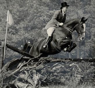 Jump is taken at Hunter Trials of the Toronto and North York Hunt, on Monday, by Edgar Burton, who rides Topsy