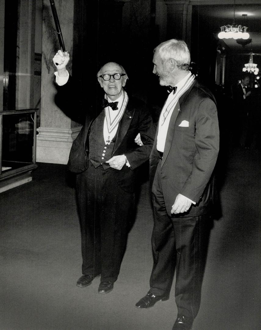 Honored citizens. Writer Morley Callaghan, left, raises cane with film director Norman Jewison in a corridor of the Legislative Building at Queen's Pa(...)