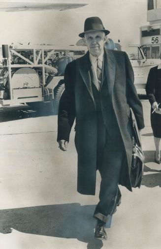 Looks fit. Clarence Campbell, ailing president of National Hockey League, strides toward his plane at Malton aiport this afternoon. He is on way to Mo(...)