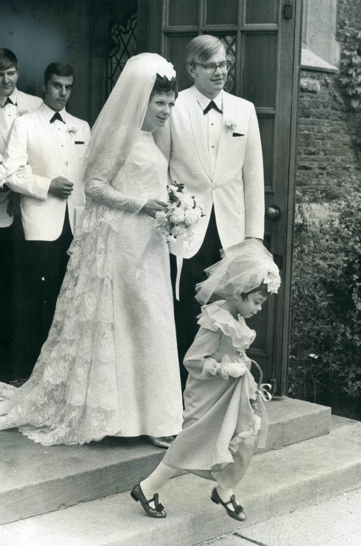 Mr. and Mrs. Norman Toivo Makela leaving church. Kathy Sherman, 5, was flower girl for the former Susan Anne Campbell