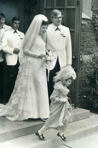 Mr. and Mrs. Norman Toivo Makela leaving church. Kathy Sherman, 5, was flower girl for the former Susan Anne Campbell