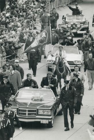parading success: Well-wishers cheer the Argonauts in a downtown motorcade yesterday that included a convertible carrying Bruce McNail, left, and John Candy, who with Wayne Gretzky own the team