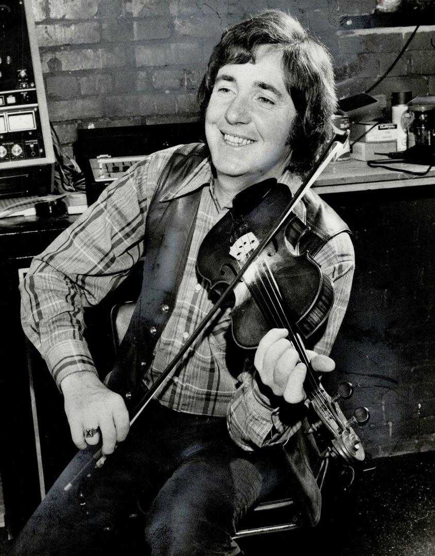 John Allan Cameron steps out of exaggerated stage character and offstage becomes warm and honest with a knowledge of music of his native Cape Breton. Popularizing this music has become a crusade