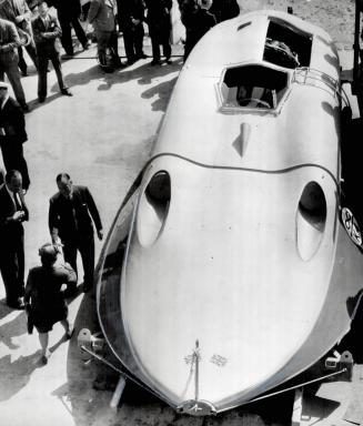 Intending to attack his own record this month, Sir Malcolm Campbell stands beside his re-designed, jet-propelled speed boat, Bluebird, at Porchester, (...)