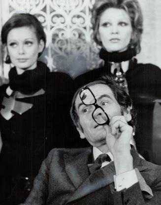 Paris designer Pierre Cardin chewing glasses