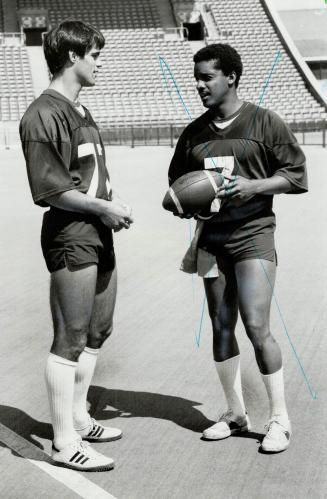 Prize catches: Jan Carinci, whom Argos considered when he was only in high school, is back from University of Maryland and, above gets some instructions from quarterback Condredge Holloway
