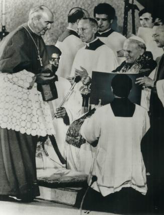 Gerald Emmett Cardinal Carter gets his red beretta from Pope John Paul II