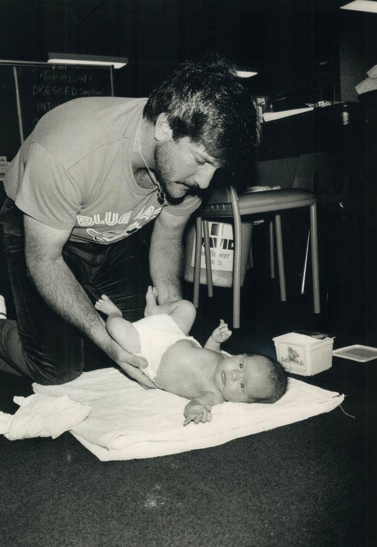 Time for necessary change. One of Bill Caudill's final jobs around the Blue Jays clubhouse yesterday was changing son Cory's diapers. The Jays packed (...)