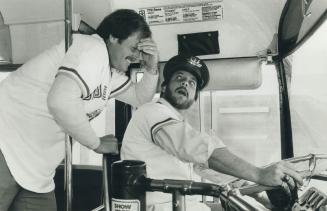 Blue Jays catcher Ernie Whitt holds his forehead in mock horror today as ace relief pitcher Bill Caudill takes a turn as a relief driver on a TTC bus (...)