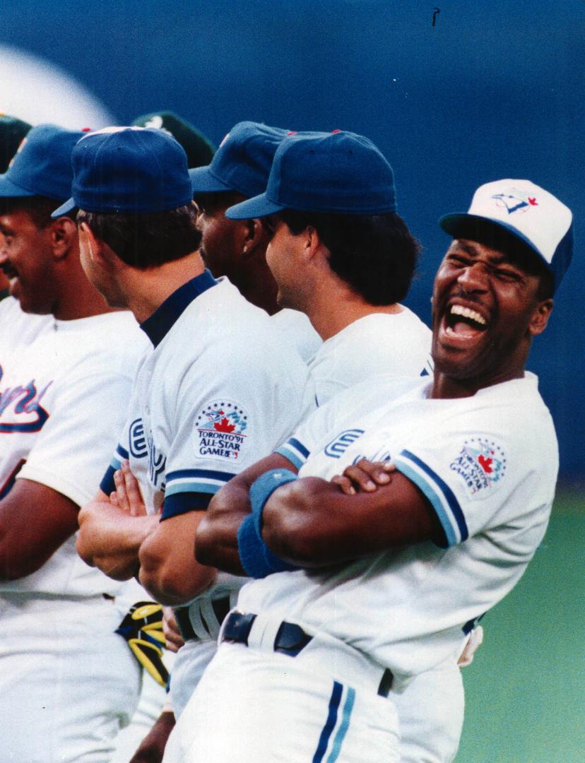 Jolly Joe: Blue Jay outfielder Joe Carter erupts in laughter after a slight snafu over the introduction of him and teammate Jimmy Key before the All-Star Game at the SkyDome last night