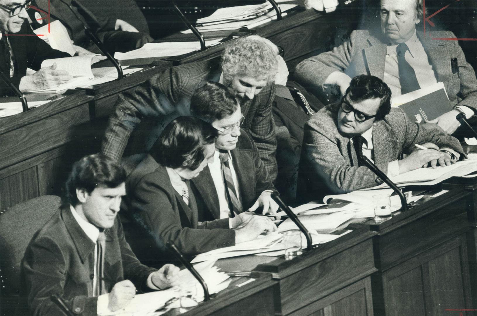 NDP front-benchers scan budget details just before starting their scatling attack on its contents last night