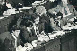 NDP front-benchers scan budget details just before starting their scatling attack on its contents last night