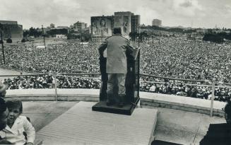 Cuban President Fidel Castro addresses a crowd in Havana celebrating the 10th anniversary of the revolution