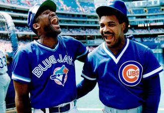 Jay Joe Carter, left, laughs with former Jay outfielder George Bell during a batting contest yesterday at the dome