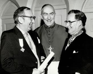 Papal honours at St. Michaels Cathedral L to R. Clare Westcott, his Eminence G. Emmett Cardinal Carter. and Chief Justice Gregory Thomas Evans, (inves(...)