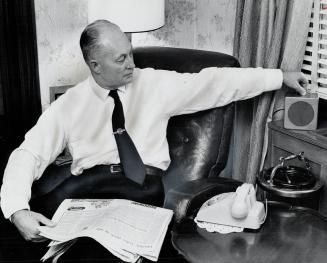 On duty 24 hours a day, Toronto deputy fire chief Charlie Chambers adjusts speaker at his home that is tuned to the Toronto Fire Department radio netw(...)
