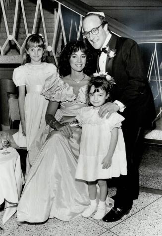 Left, Richard LeVine - the groom's brother and best man - with his wife, Gail, and their two daughters