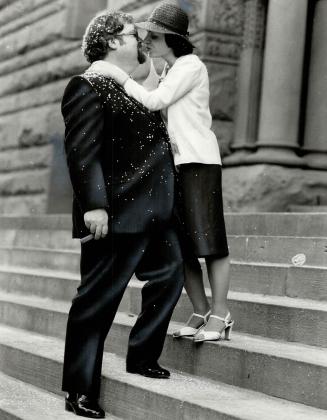 Weddded kiss: Sunday editor Geoff Chapman with bridge Bilgi on the steps of old city hall after their wedding last Thursday