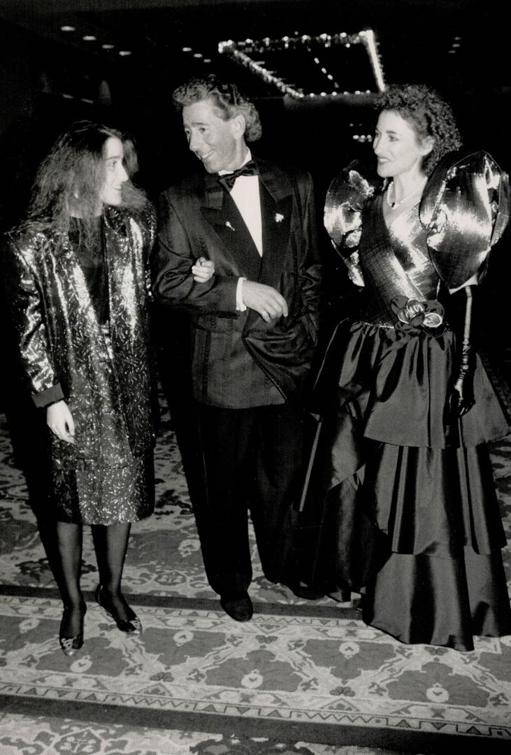 Alan Cherry with daughter Lisa, left, in a Wayne Clark outfit, and wife Rosalyn, in gold and black gown
