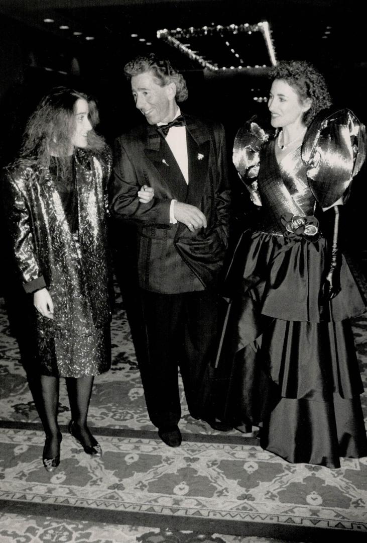 Alan Cherry with daughter Lisa, left, in a Wayne Clark outfit, and wife Rosalyn, in gold and black gown