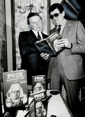 New book: Don Cherry, left, was at the Westbury Hotel yesterday to get an autograped copy of Star hockey writer Frank Orr's new book, PUCK is a four letter word
