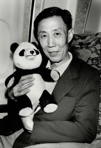 Li Guiling: A Chinese official accompanying the pandas holds a replica during flight