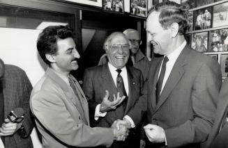 Johnny Lombardi, centre, and son Lenny greet Jean Chretien at Lombardi's radio station today before an on-air interview