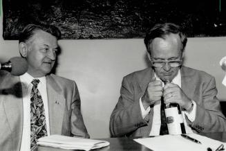 Checking it out: Liberal MP Jesse Flis (Parkdale High Park) looks on yesterday as party leader Jean Chretien sniffs Chinese cooking wine which residents say has become popular in the area