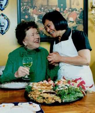 Child's Portion. Mely Jumawang Jumarang, right, serves Far Eastern appetizers to Julia Child yesterday to mark the celebrity cook's Star-sponsored vis(...)