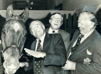 King Clancy horsing around. King Clancy, vice-president of Maple Leaf Gardens, horses around with Time Again, one of the mounts that will appear next (...)