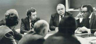 Clark in conference with Steve Paprowski, House whip, and Hamilton MP Lincoln Alexander (right)