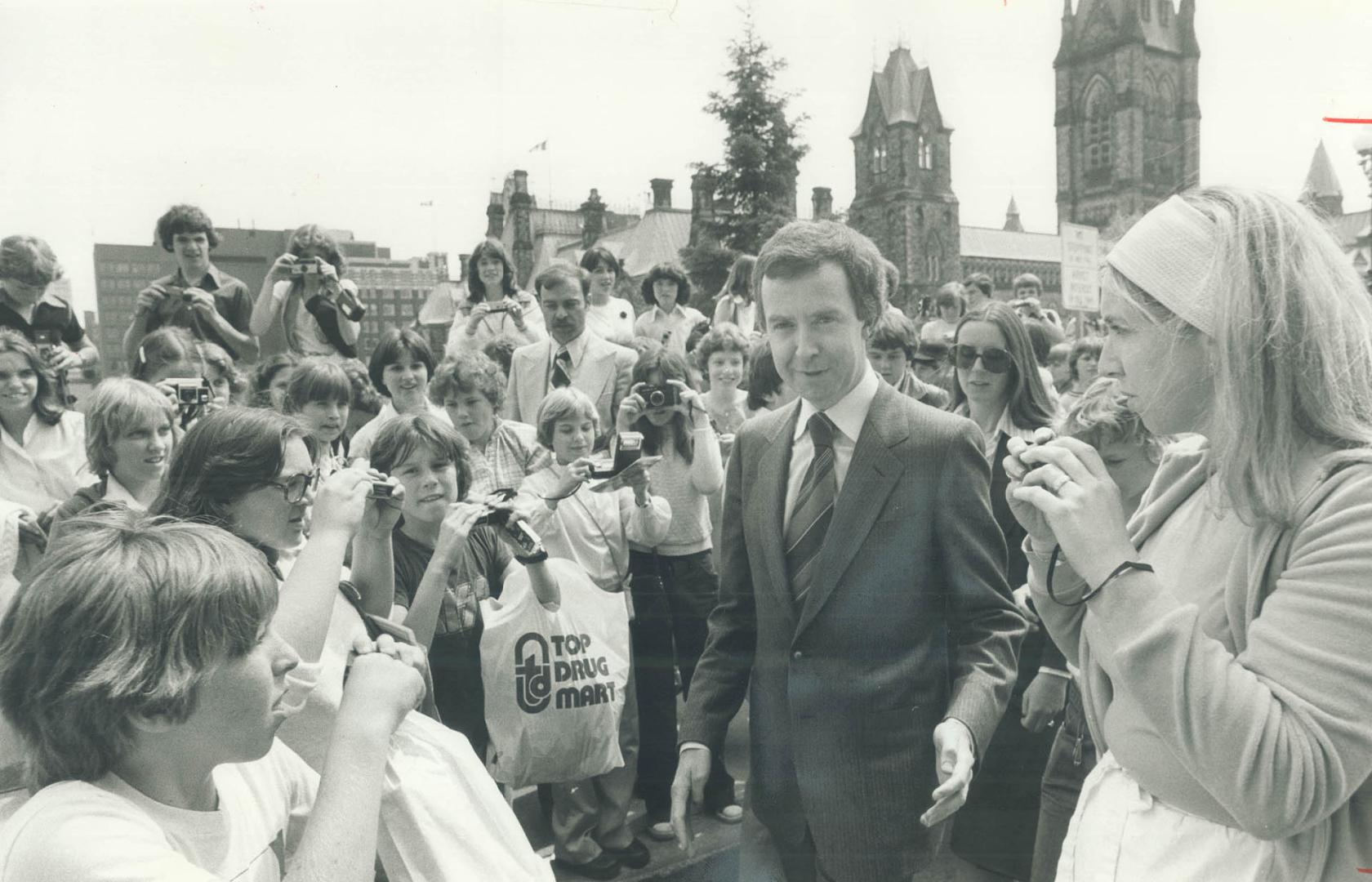Joe Clark's the centre of attraction as he meets a party of camera-clicking schoolchildren on Parliament Hill