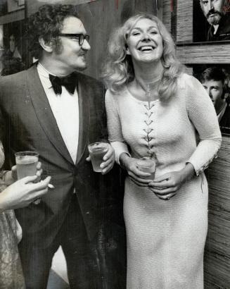 Actress-Singer Dinah Christie, who stars in the Italian Straw Hat at the Avon Theatre, talks with artistic director Jean Gascon at party. She wore white knit gown