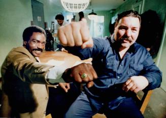 Friends: Rubin Hurricane Carter, who portrays trainer Fast Eddy in the movie, left, and George Chuvalo, who plays ex-champ Gentleman Jim, compare knuckles during pause in filming Rubber Match