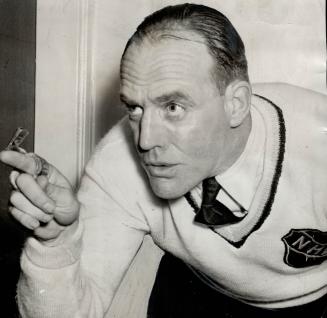Referee King Clancy, chief of PRexv Campbell's hockey policemen, caught in a characteristically dramatic pose during the progress of Saturday night's (...)