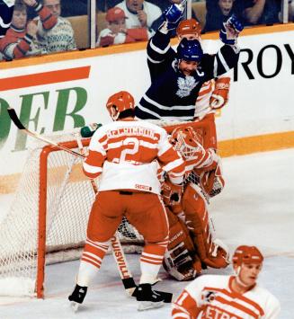 Rare goal: Leaf captain Wendel Clark celebrates a goal by Brian Bradley - his first ever for Toronto - as Detroit defenceman Brad McCrimmon looks on in the first period last night at the Gardens