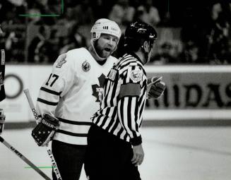 AW, C'Mon Ref: Leaf captain Wendel Clark expresses his displeasure with a call by referee Andy vanHelkemond, who seems preoccupied with other things