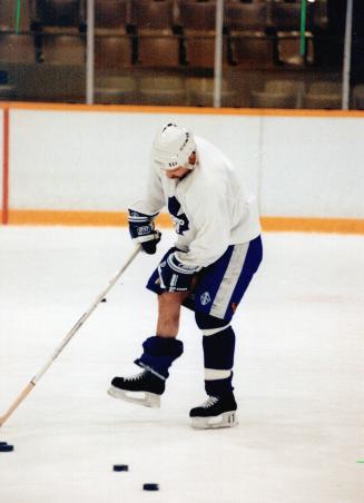 Isn't that Tiny Tim? He may look like Bob Cratchit's little boy, the one with the suspect leg, but actually it's just Wendel Clark, having some trouble with one of his socks