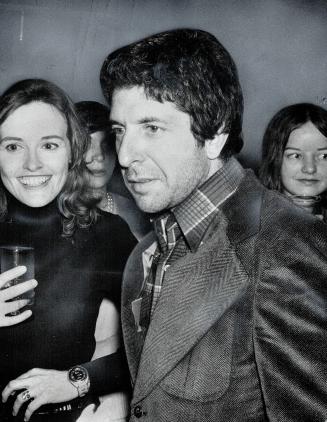 Poet Leonard Cohen, bewildered but surrounded by girls at a party for himself and Irving Layton, thrown by publishers McClelland and Stewart at the Fi(...)