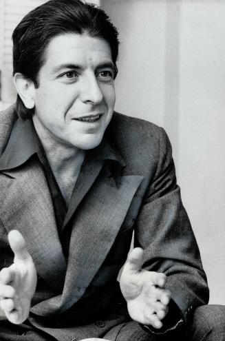His hair combed back, Greek-style, from his tanned forehead, with a black open-necked shirt under a plain gray suit, Leonard Cohen yesterday talked wi(...)