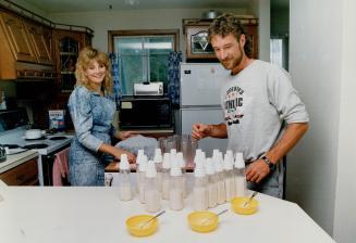 Bottle brigade: Baby feeding time is a big production at the Holland Landing home of Mae and Wayne Collier, the thrilled but wilted parents of test-tube quints who are the darlings of the community