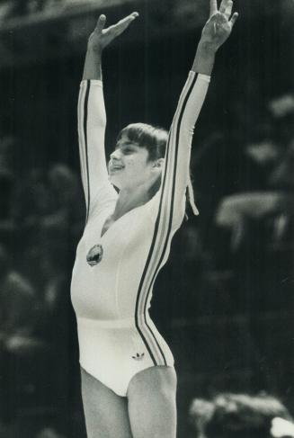 Perfect smile. Romania's Nadia Comaneci poses in triumph yesterday after getting two more perfect scores of 10 on beam and uneven bars, to add to her (...)