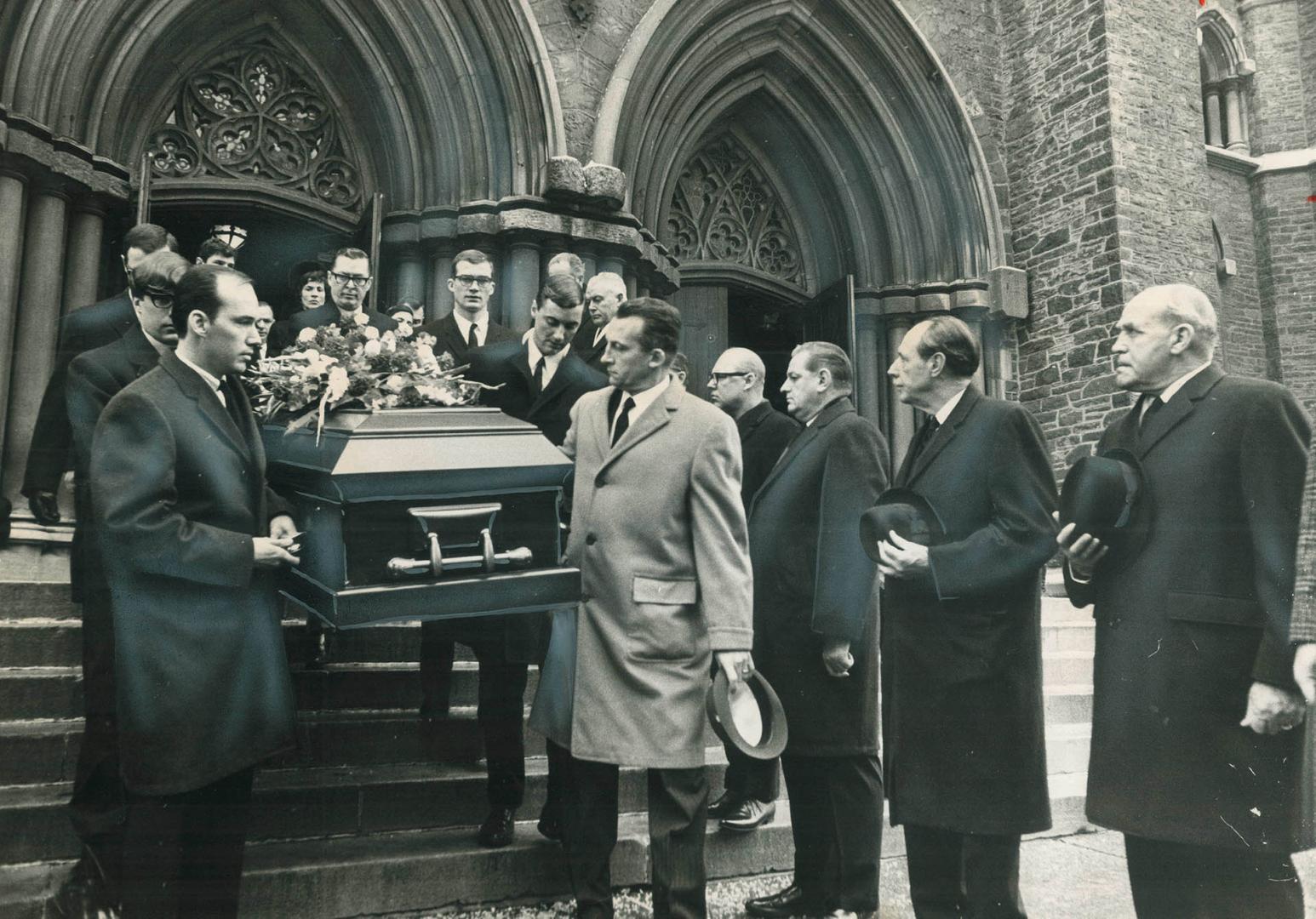 Six nephews carry casket bearing body of Hockey Hall-of-Famer Charlie Conacher down steps of St