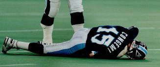 Down for the count: A sacked John Congemi sprawls on turf with a concussion but returned late in the game to lead Argos' final touchdown drive
