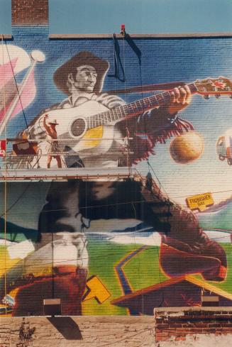 Artist Bill Wrigley puts the finishing touches on a mural of folk hero Stompin' Tom Connors on the northwest corner of Church and Dundas Sts. The mura(...)