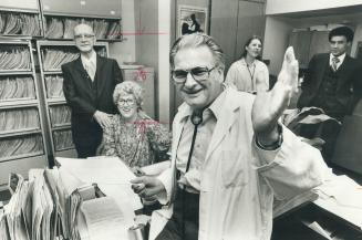 Dr. Robert Cooper's back at work, welcomed by patient Ernest Hunter and staff