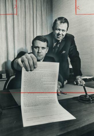 Jim Corrigall admires his contract
