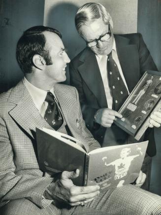 Frank Consentino (left) admires gold medals in boxing won by Lefty Gwynne at 1932 Olympic Games in Los Angeles